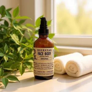 Rockstar Face & Body Original on a sunny windowsill beside rolled towels